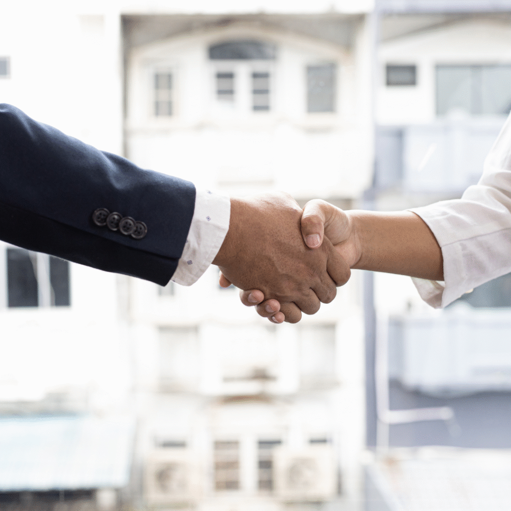 Handshake between two professionals symbolizing collaboration and partnership in digital marketing services.