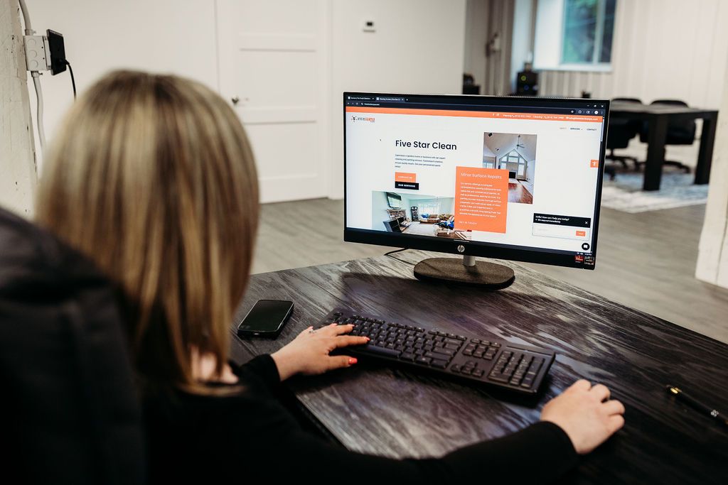 Person using a computer to view a website for "Five Star Clean," showcasing a clean and modern design, emphasizing user engagement and conversion-focused elements.